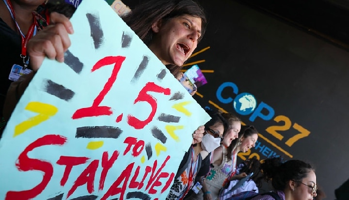 COP27 Woman Holding A banner