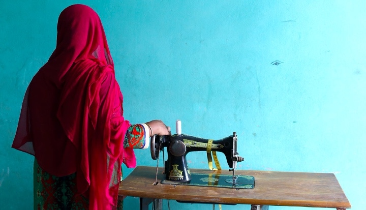 Women on a blue background with sewing machine