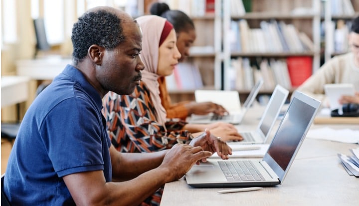 migrant-students-using-laptops.jpg_s=1024x1024&w=is&k=20&c=WutMSTdTW_C28z8GtsC9gIQQG3nyz3tEH3HRUnFm9Gw=