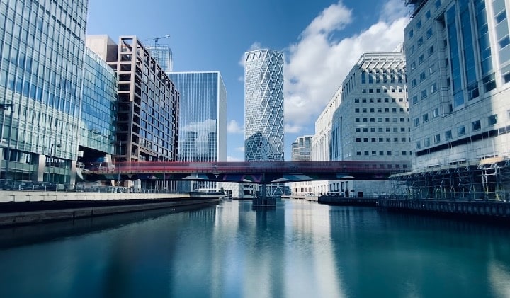 White and blue high rise buildings near a body of water in the day time