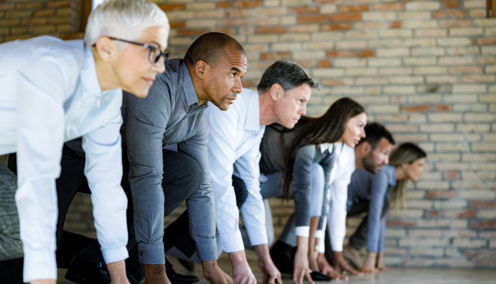 corporate culture of social impact - Large group of business people preparing for a race on a starting line in the office