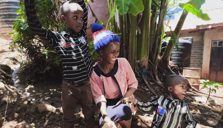 woman with two sons in rural setting