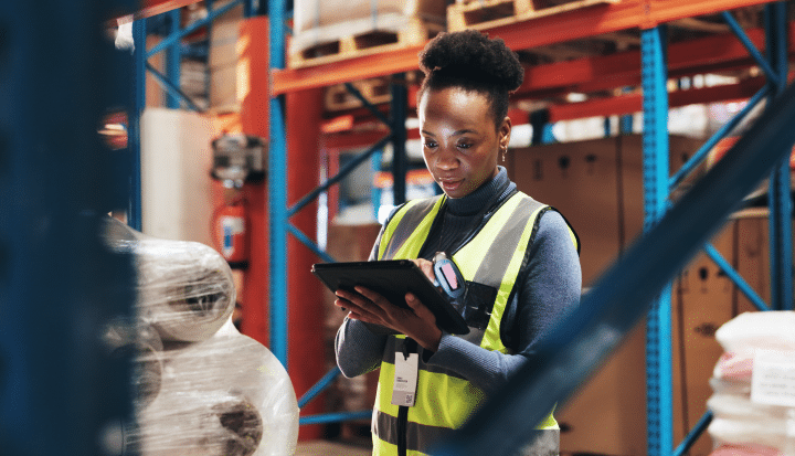 Young African, female person or employee checking technology for supply chain stock photo